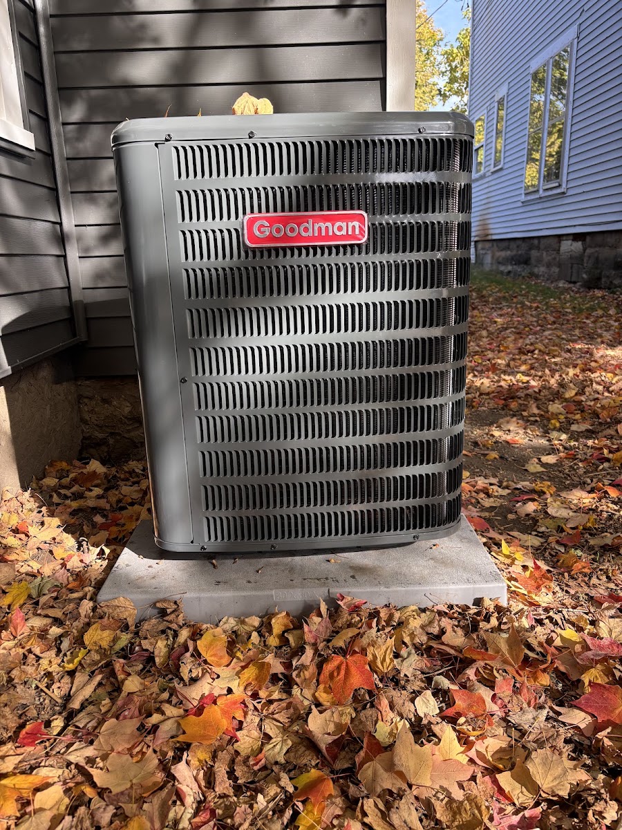 New Goodman air conditioner condenser installed outside a home