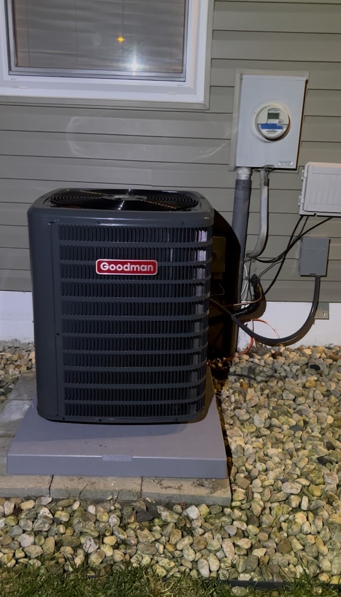 New Goodman air conditioner condenser installation with electrical hookup